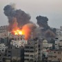 Smoke and fire from an Israeli bomb rises into the air ove Gaza City