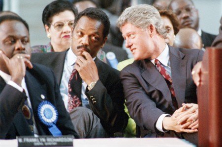 Democratic presidential candidate Bill Clinton, right, leans over to converse with the Rev. Jesse Jackson as the two attended the 112th annual national convention U. S. R. at the Georgia Dome in Atlanta on Wednesday, Sept. 9, 1992. Clinton addressed the group about national health care. (AP Photo/Curtis Compton)