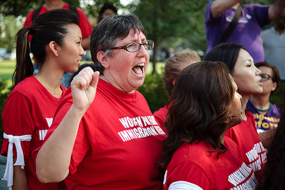 Sammie Moshenberg, operations director of the Washington NJWC gives Communist salute during sit-in pro-immigration protest in D.C. this past week.