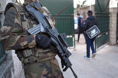 An armed French soldier secures the access to the 'La Source' Jewish school in Marseille, southern France, on January 12, 2016, a day after a teenager, armed with a machete and a knife, wounded a teacher slightly before being stopped and arrested.   The teenager who attacked the Jewish teacher in Marseille on Monday is a Turkish citizen of Kurdish origin, who said he acted in the name of the militant Islamist group Islamic State, the prosecutor in the southern French city of Marseille said. / AFP / BORIS HORVAT        (Photo credit should read BORIS HORVAT/AFP/Getty Images)