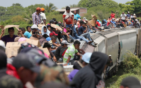JUCHITAN, MEXICO - AUGUST 06:  Central American immigrants ride north on top of a freight train on August 6, 2013 near Juchitan, Mexico. Thousands of Central American migrants ride the trains, known as 'la bestia', or the beast, during their long and perilous journey through Mexico to reach the U.S. border. Some of the immigrants are robbed and assaulted by gangs who control the train tops, while others fall asleep and tumble down, losing limbs or perishing under the wheels of the trains. Only a fraction of the immigrants who start the journey in Central America will traverse Mexico completely unscathed - and all this before illegally entering the United States and facing the considerable U.S. border security apparatus designed to track, detain and deport them.  (Photo by John Moore/Getty Images)